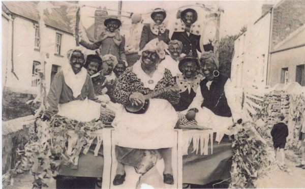 Copy of an undated photograph of a carnival float in Llangwm Pembrokeshire showing a group of people unnamed in fancy dress